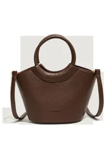 Stylish brown leather bucket handbag with round handle and shoulder strap for women daily use.