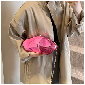 Pink acrylic meteorite clutch bag with golden chain strap, stylish evening party accessory.