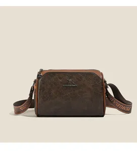 Vintage brown crossbody pillow bag detail showing premium distressed PU leather and chic strap text.