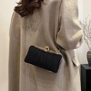 Black rhinestone evening clutch bag with gold chain and ring clasp for women party dress.