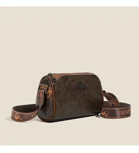 Retro vintage brown shoulder pillow bag detail view, elegant crossbody handbag for women.