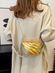 Golden shell acrylic crossbody bag with chain strap, stylish niche design accessory for women.