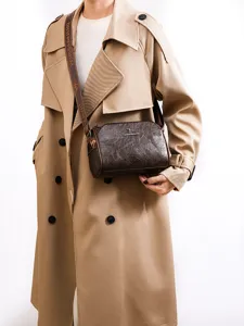 Vintage brown leather shoulder bag women's crossbody barrel bag with wide printed strap.