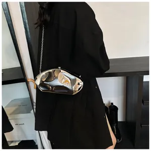 Detail view of the unique irregular metallic liquid clutch bag with silver chain strap.