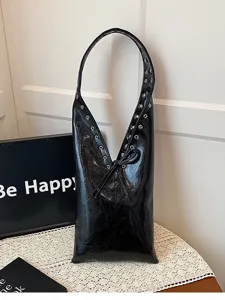 Black glossy patent leather shoulder underarm bag with metal eyelets and lace-up design.