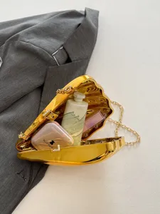 Gold acrylic shell clutch bag with chain strap, stylish evening crossbody bag for women.