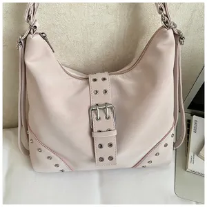 Pink PU leather shoulder bag detail showing metallic buckle, studs and zipper closure.