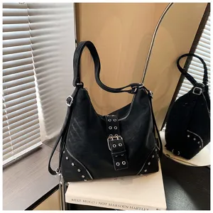 Detailed view of a stylish black PU leather hobo tote bag with metal buckles and rivet decor.