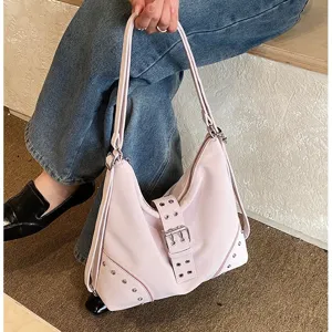 Detail shot of the trendy pink slouchy shoulder bag featuring metal buckle and chic rivet accents.