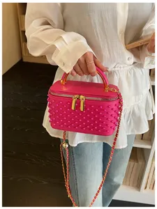 Pink pearl studded vanity crossbody bag detail, elegant gold hardware and chic chain strap.