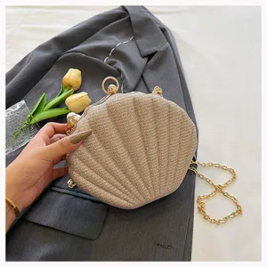 Elegant glitter shell evening bag with gold chain strap, stylish kiss-lock clutch purse.