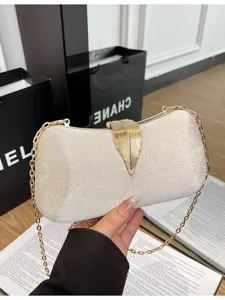 Elegant sparkly evening clutch bag with gold leaf clasp and chain strap for parties