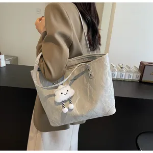 Detailed view of the stylish large capacity tote bag with grey crumpled texture and cloud charm.