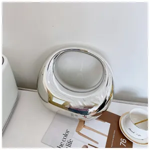 Elegante bolso de mano plateado metálico con diseño de anillo geométrico único para mujeres.