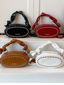 Trendy women oval crossbody bag with knotted handle and metal rivets, stylish daily purse.