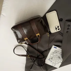 Dark brown patent leather vintage top handle bag, stylish Boston crossbody bag for women.