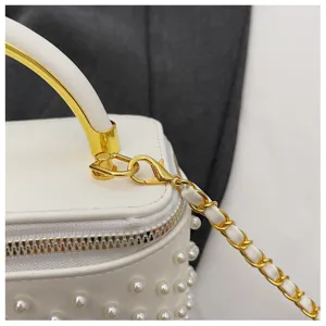 White pearl box handbag for women, chic metal handle and chain crossbody bag detail.