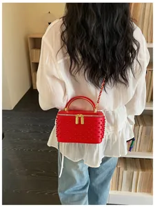 Red studded box handbag with chain strap and top handle. Elegant mini crossbody bag.