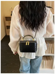 Black studded box shoulder bag detail, stylish pearl decoration and gold chain strap.