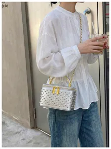 Silver studded box shoulder bag with chain strap and top handle for women trendy fashion detail