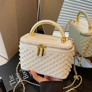 White pearl embellished vanity box handbag with gold handle and chain crossbody strap for women.