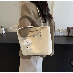 Detail view of stylish large capacity casual tote bag with cute cloud charm for daily commute.