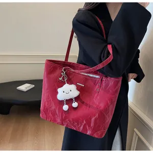 Red tote bag detail view, casual large capacity handbag featuring cute cloud pendant.