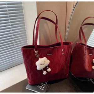 Red crinkled tote bag detail, large capacity shoulder handbag with cute cloud keychain.
