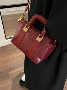 Dark red patent leather handbag women's retro top-handle crossbody bag worn on body main view