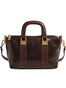 Vintage dark brown glossy handbag for women, stylish top handle commute crossbody bag.