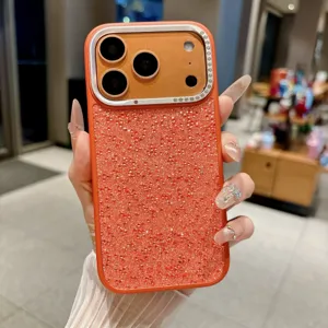 Detailed shot of luxury glitter rhinestone phone case with camera protector, orange sparkle.