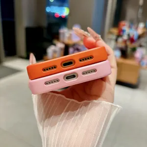 Close up view of colorful protective phone cases in orange and pink with precise cutouts.