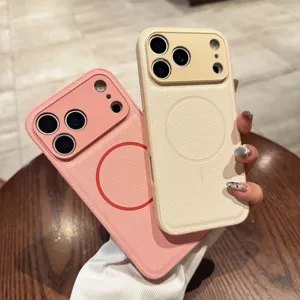Detail shot of plain leather MagSafe phone cases in pink and beige, showing fine camera cutout.