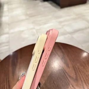 Detailed side view of premium plain leather phone cases in pink and yellow with precise buttons.