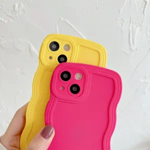 Close-up detail shot of liquid silicone wavy phone cases in bright yellow and pink.