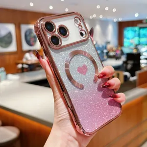 Close-up detail of gradient glitter MagSafe phone case with pink heart and rose gold frame.