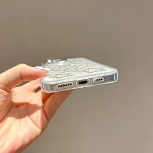 Close-up detail of clear rhinestone star phone case bottom, precise cutouts and sparkling crystals.
