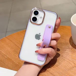 Detailed view of clear electroplated phone case with purple wrist strap on wooden table surface.
