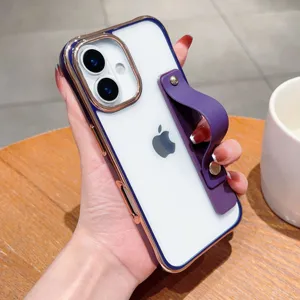 Close-up detail of transparent phone case with electroplated gold frame and purple wrist strap stand.