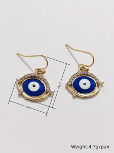 Detailed view of fashionable evil eye rhinestone gold hook earrings, chic design for women.