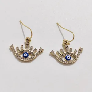 Detailed view of trendy rhinestone evil eye drop earrings featuring sparkling crystal design.