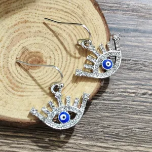 Chic rhinestone evil eye drop earrings, sparkling crystal detailed fashion jewelry detail view.