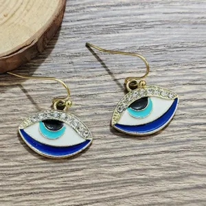 Evil eye hook earrings with sparkling rhinestones and blue enamel details, unique fashion design.
