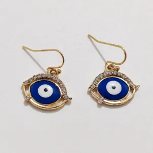 Detailed view of evil eye drop earrings, gold plated alloy with blue enamel and sparkling rhinestones.