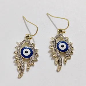 Exquisite rhinestone evil eye drop earrings with gold hooks, unique fashion statement jewelry.