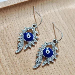 Evil eye rhinestone earrings detail shot showcasing unique design and shimmering crystals.