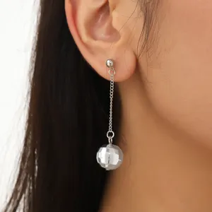 Close-up of silver long chain disco ball pendant stud earrings showing metal texture and details.