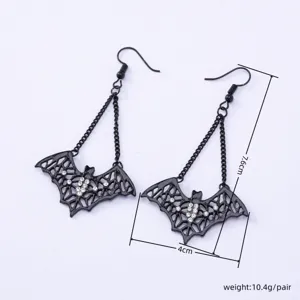 Detailed shot of dark gothic bat earrings featuring rhinestone crystals and black chains.