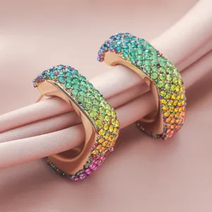 Colorful rhinestone geometric hoop earrings detail view, sparkling rainbow crystal design.