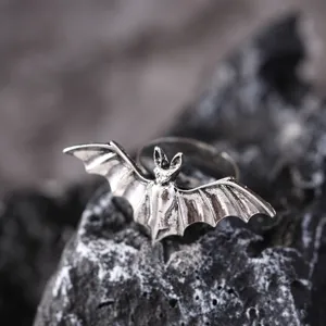 Close up detail of vintage silver bat ring, gothic punk style jewelry macro photography.